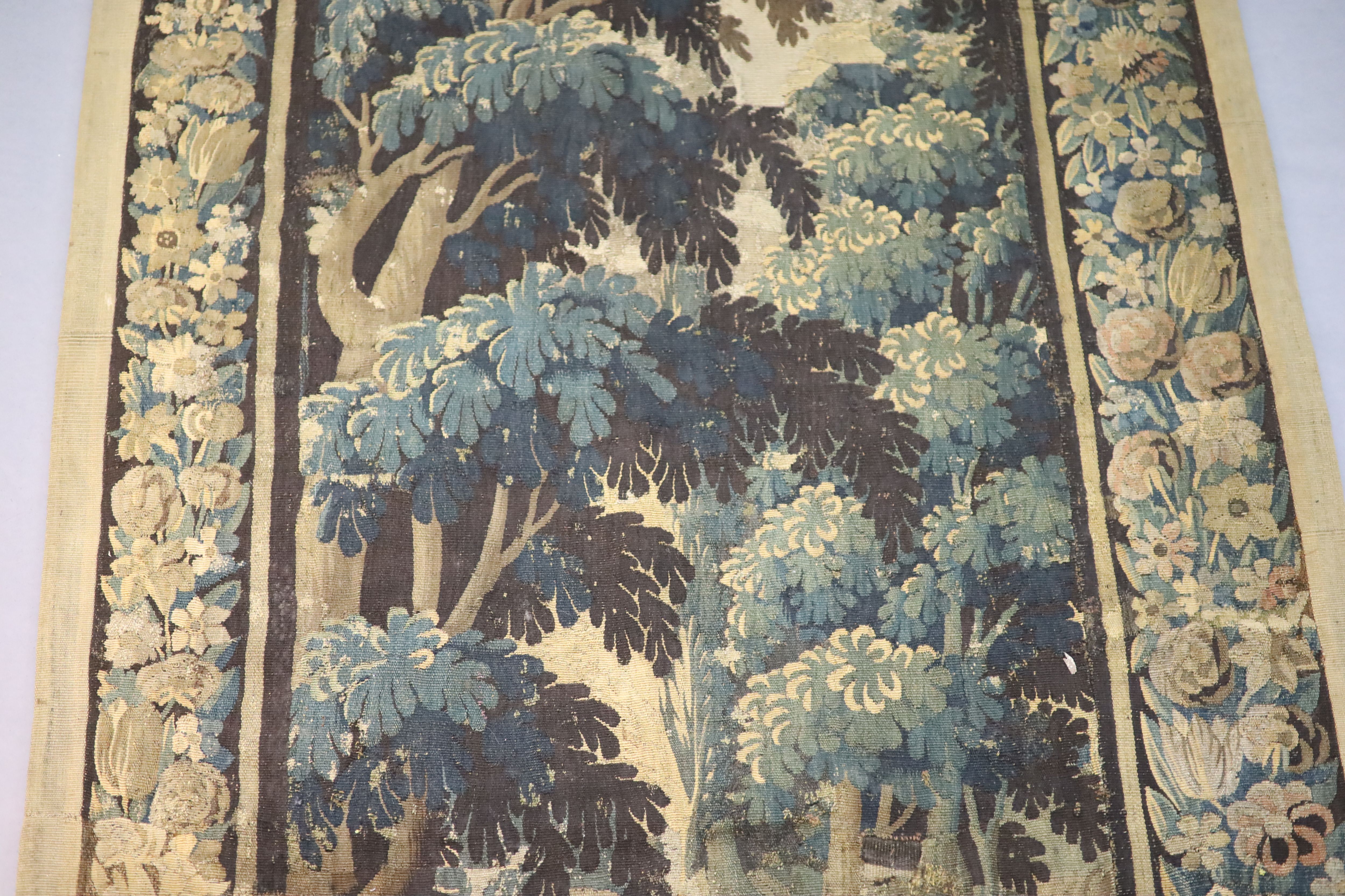A 17th century Flemish verdure tapestry wall hanging, 8ft 1in. x 3ft 11in.
